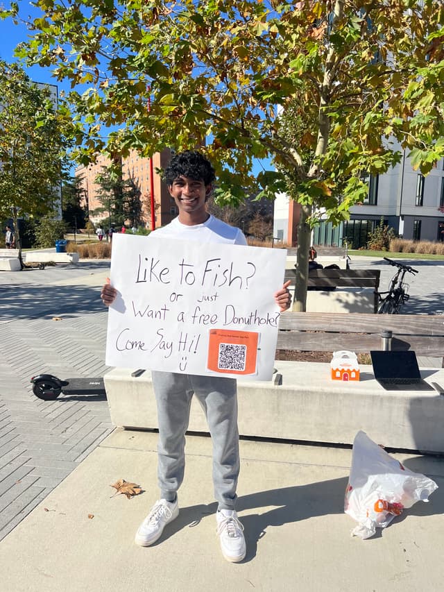Outside of the dining hall giving out donut holes